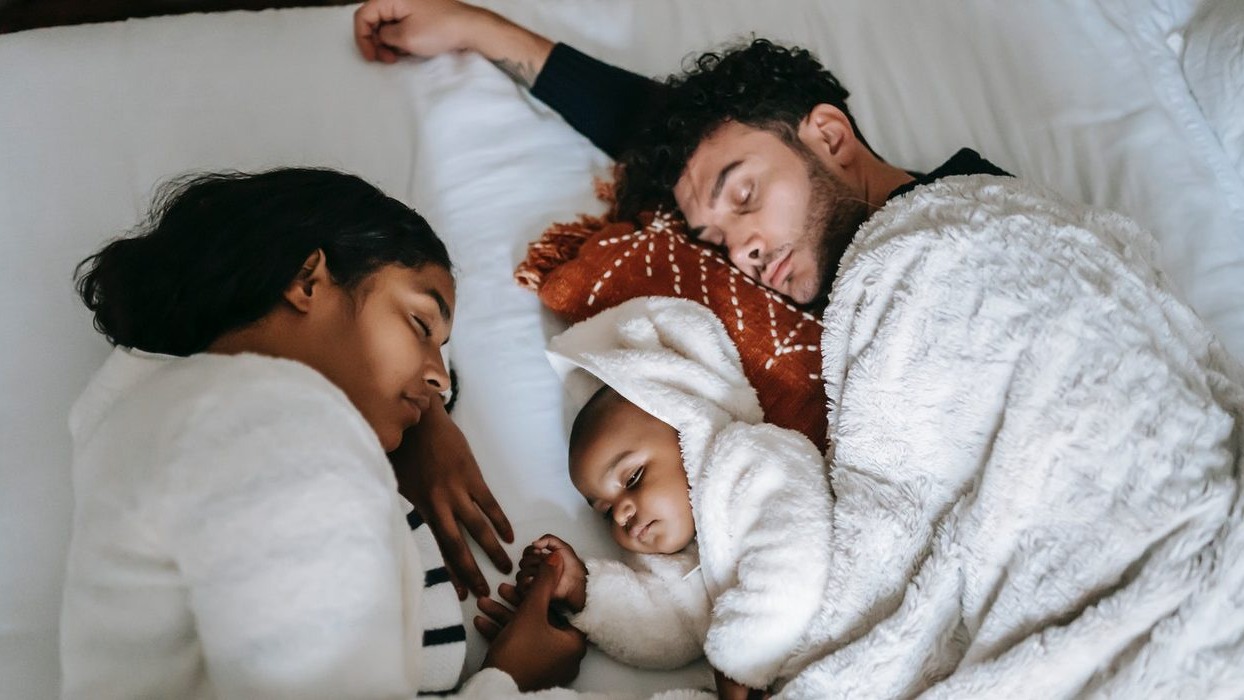 Parents cuddling with child