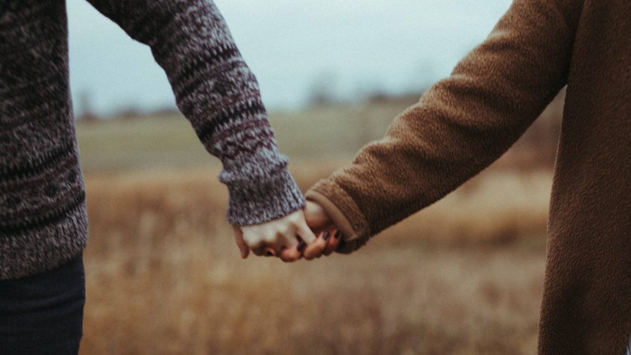 Two people holding hands