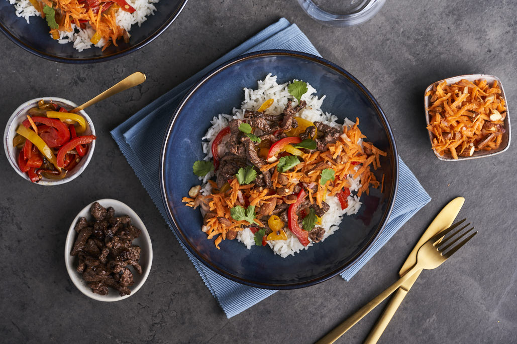 Rijst met kruidige runderreepjes en wortelsalade