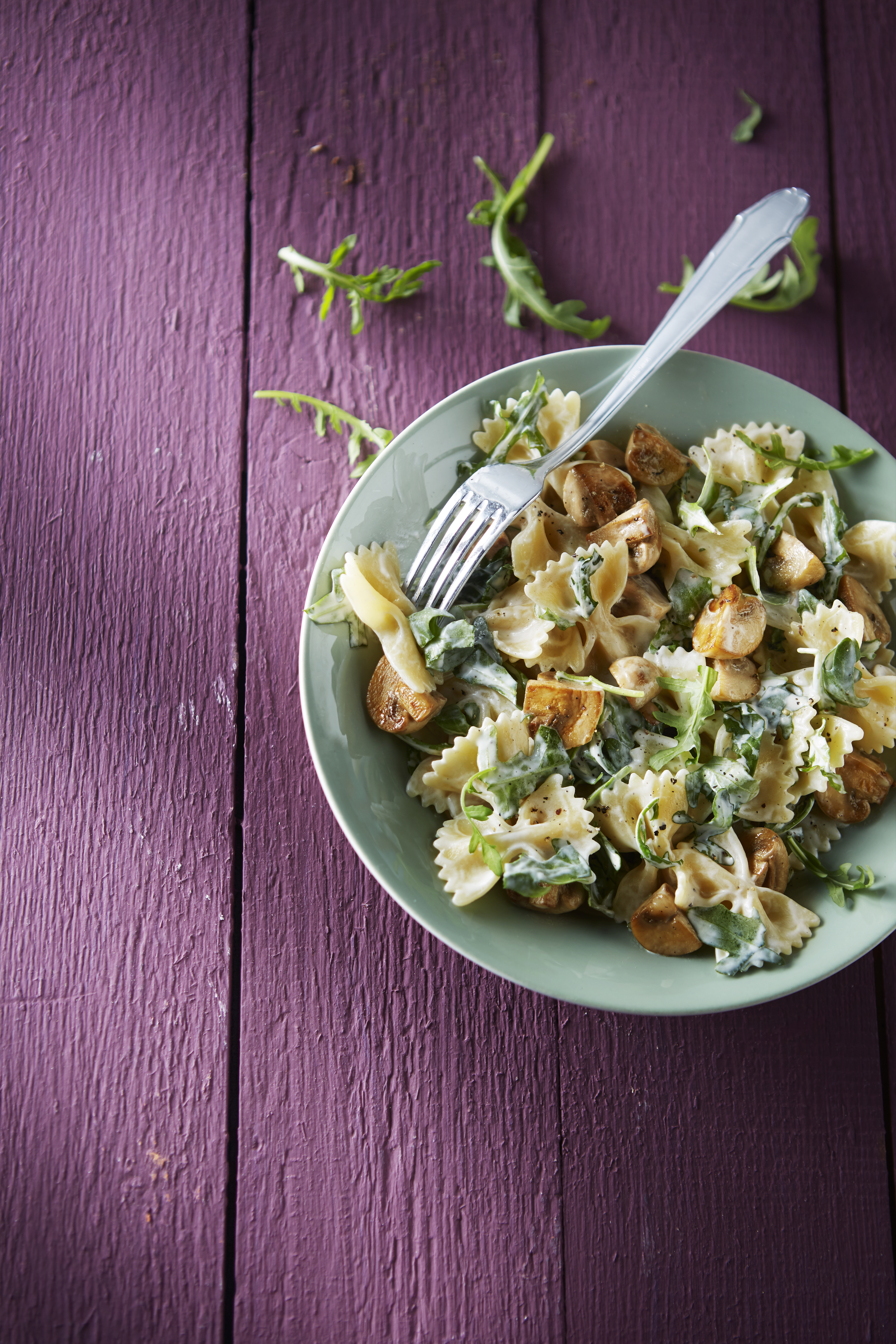 Pasta met champignons en rucola