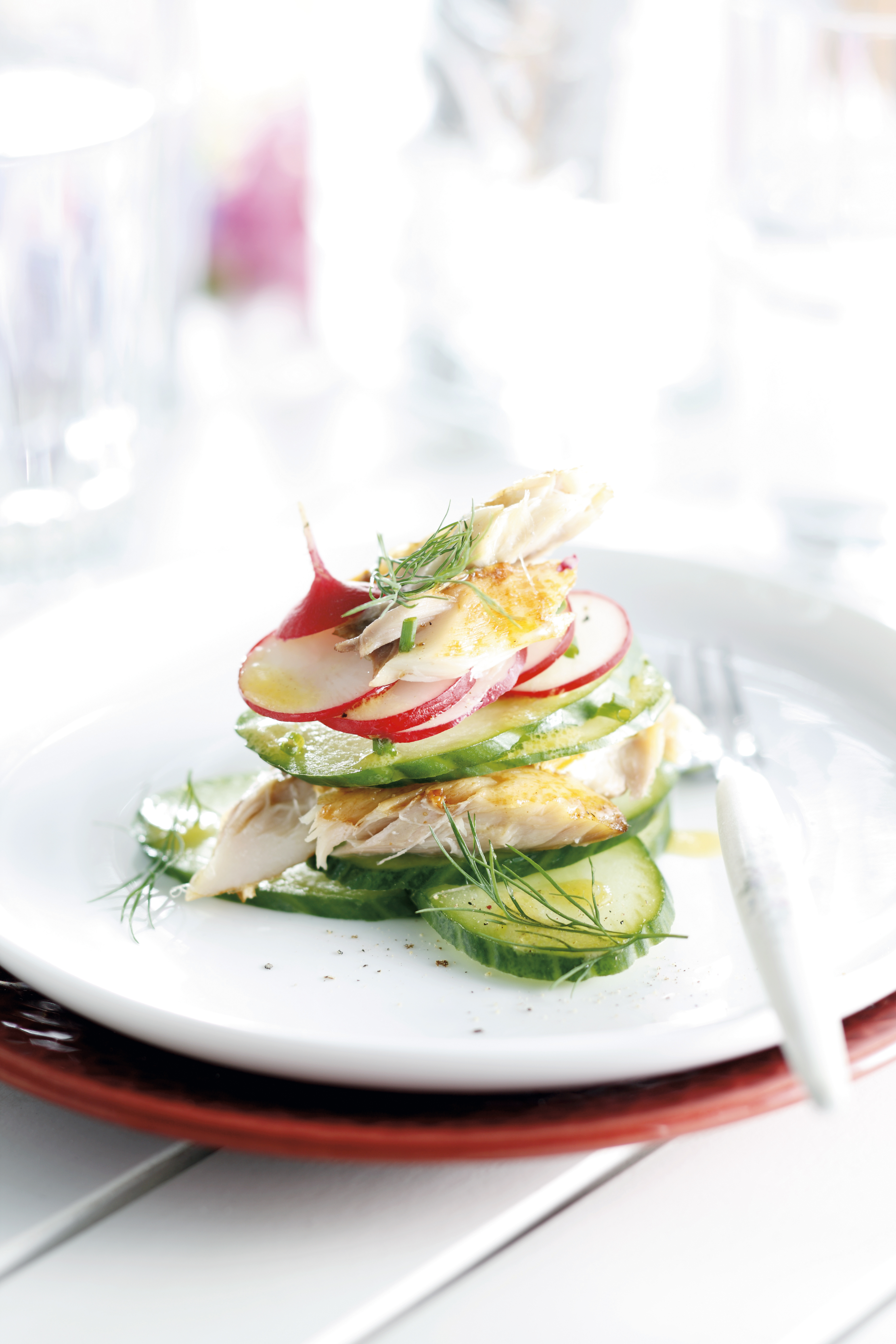 Gestapeld taartje van gerookte makreel, komkommer en radijs