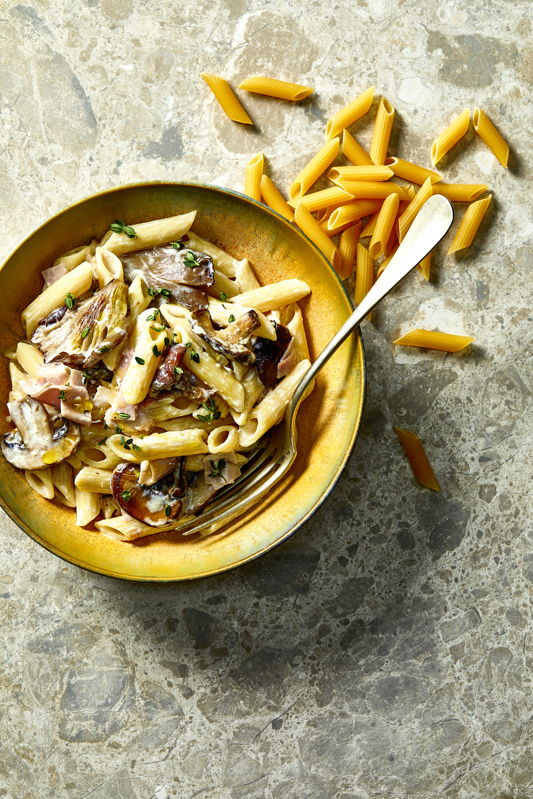 Penne met romige paddenstoelensaus en ham