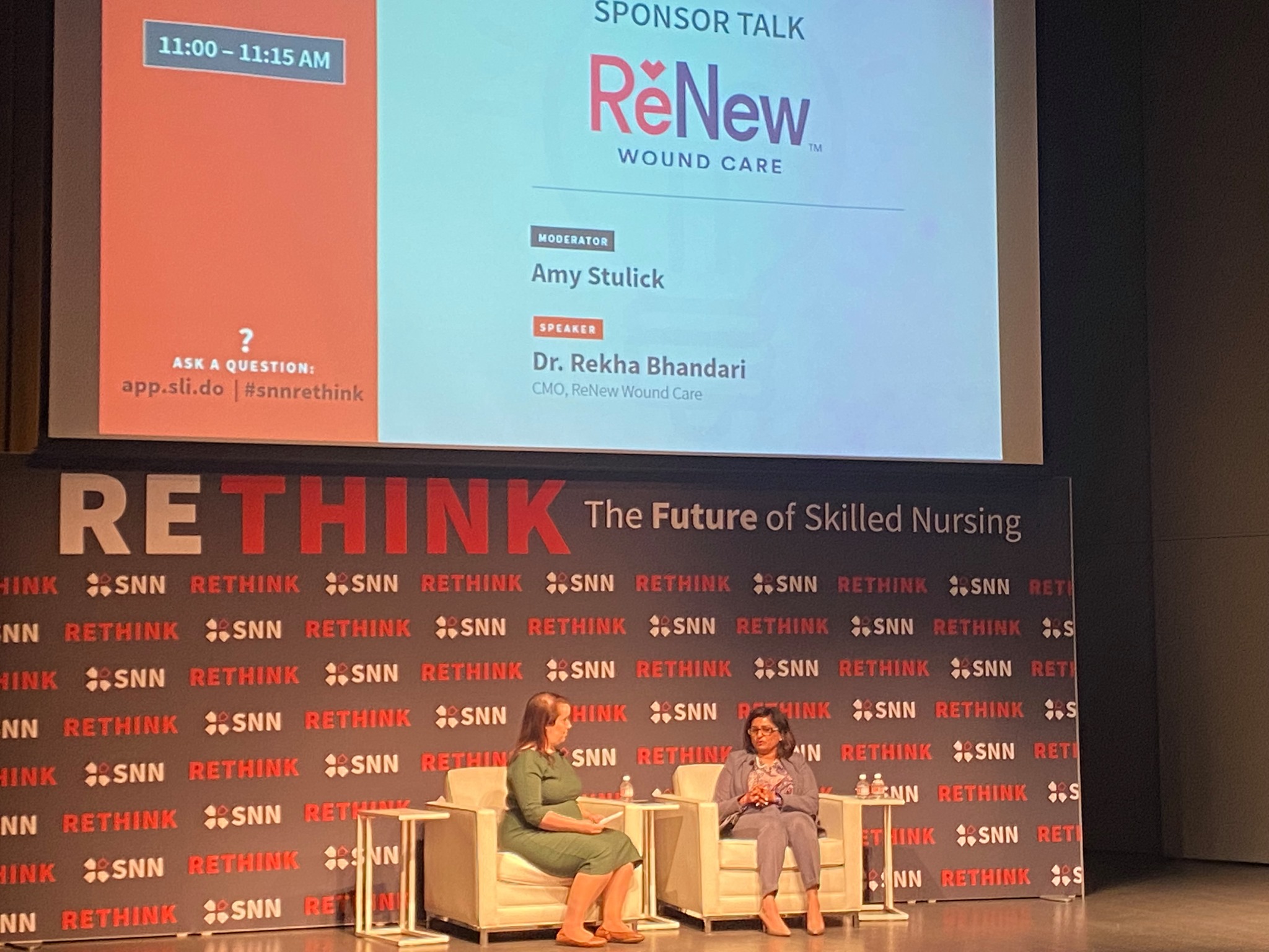 Amy Stulick and Dr. Reksha Bhandari having a talk on stage at the Rethink conference