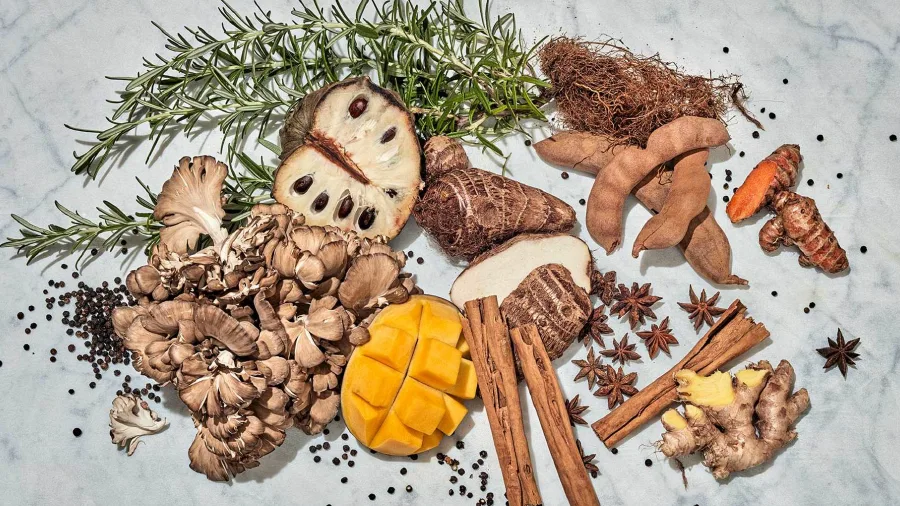 pile of cut up fruits and spices on a marble background