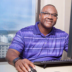 An associate working at his computer.