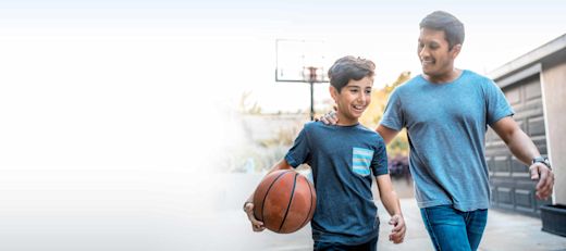 A man and his son playing basketball.