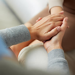 Adults offering a comforting hand.