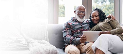 A couple reviews their finances on the couch