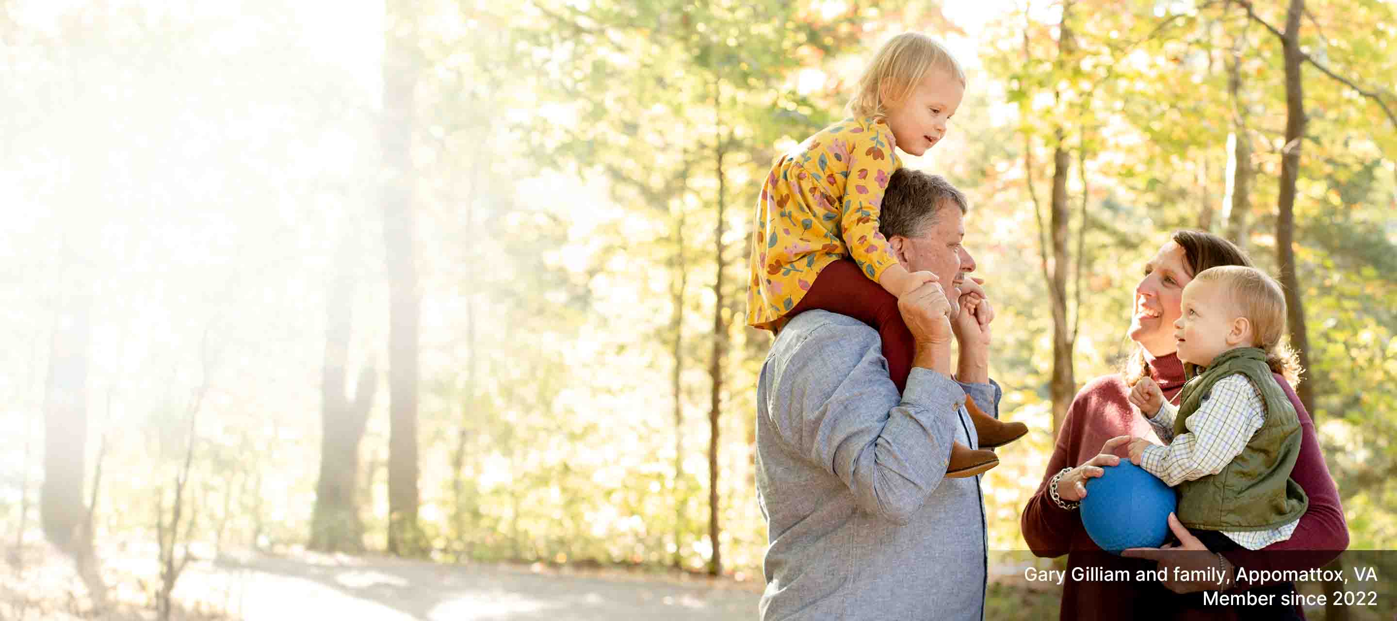 Gary Gilliam, his wife and two small children, WoodmenLife members since 2022, take a stroll on a sunny, fall day in Appomattox, VA