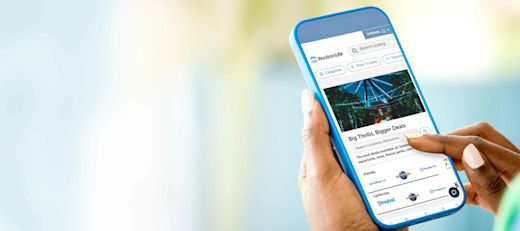 Person navigating WoodmenLife's discount program, Life's Perks, on a mobile phone.