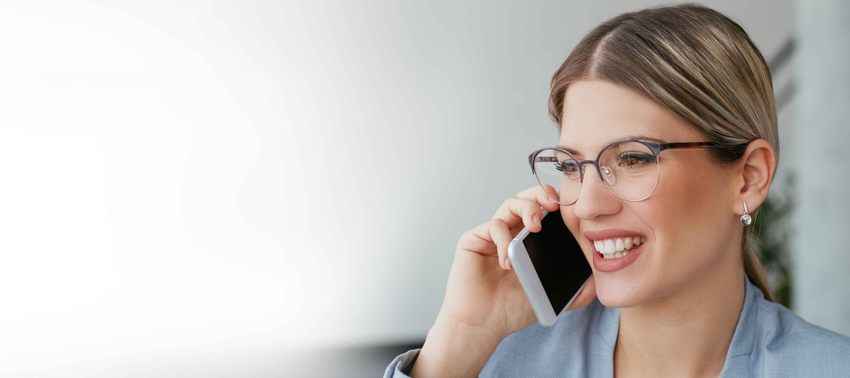 A young, white, female professional talks on the phone