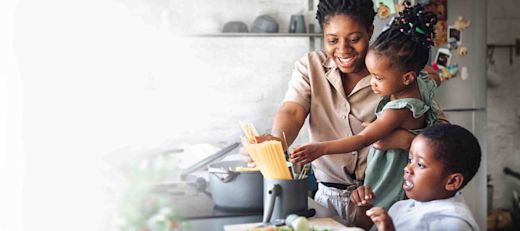 A mother cooks with her children