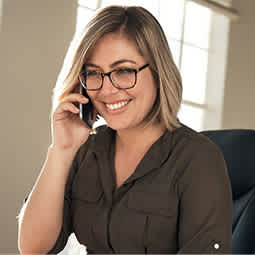 A professional woman smiles while discussing her career goals.
