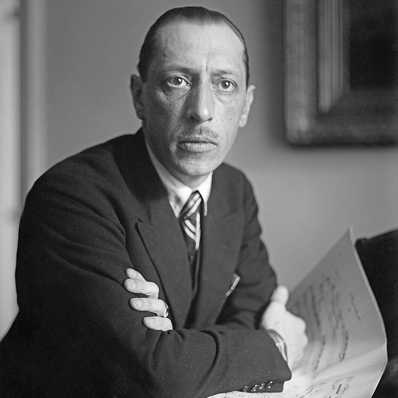 Igor Stravinsky sat at a piano with sheet music in front of him