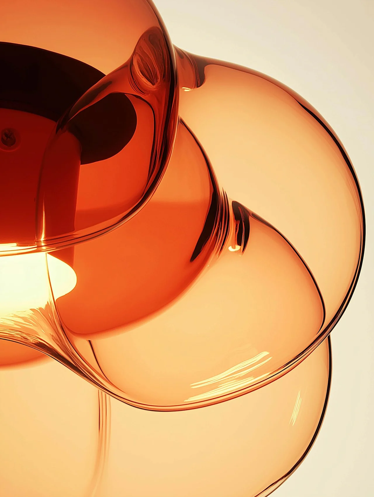 A hand-blown amber glass pendant, close up