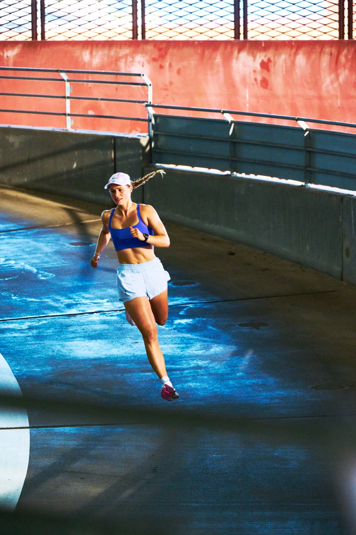 A runner in a sunlit car park