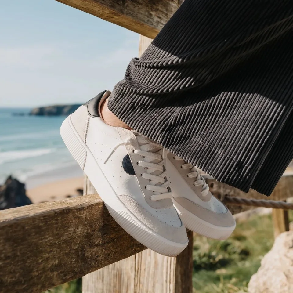 Lay Day Seas sneakers on a beach fence