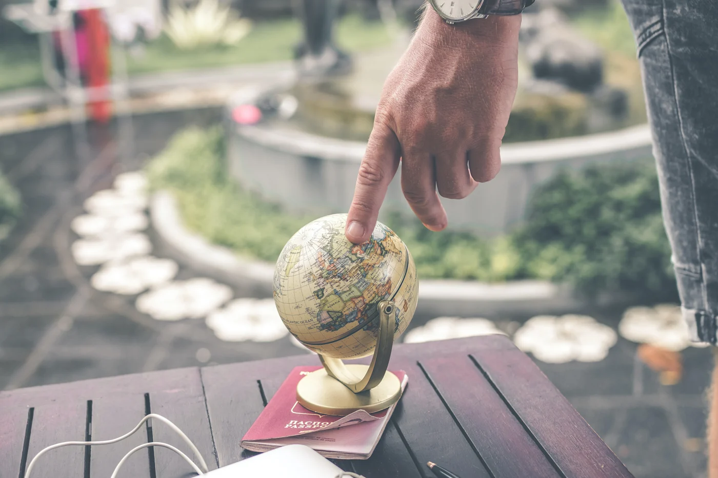 finger pointed to globe representing the article Tricks to Make your Gatsby Localization Project a Success