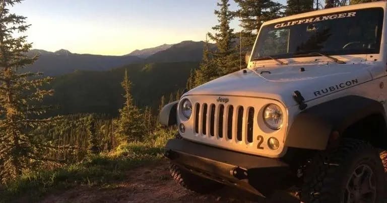 Jeep on a mountain trail at sunset