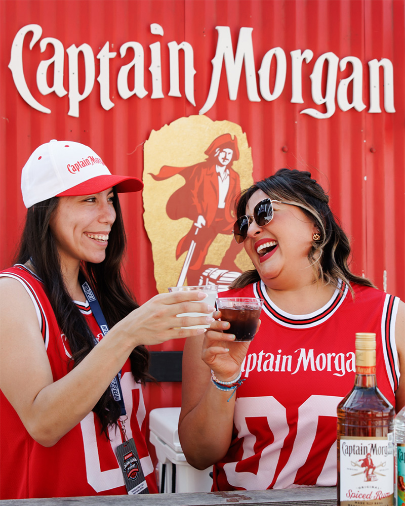 Two people drinking Captain Morgan cocktails