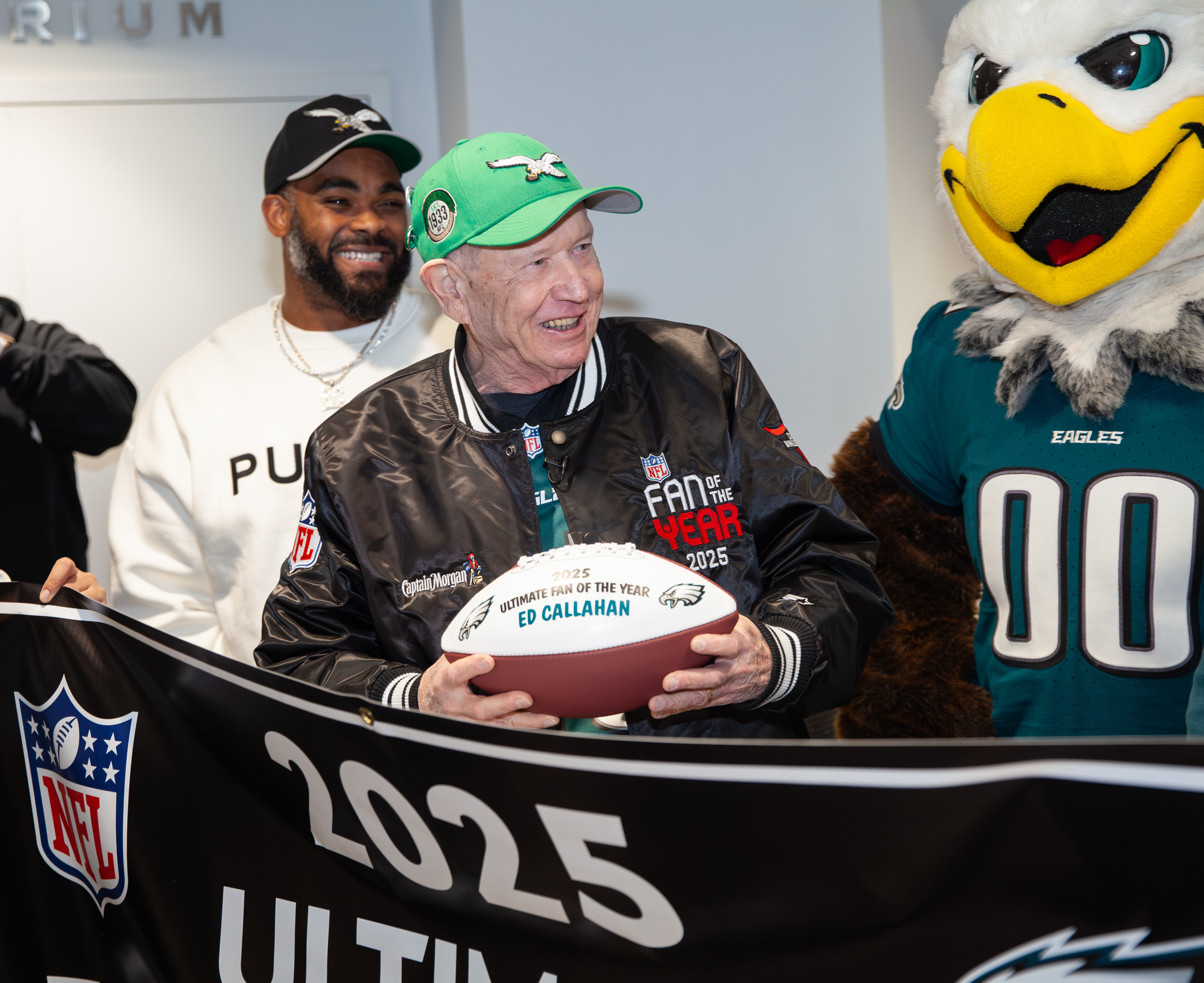 Rams Mascot holding jersey with fan holding oversized ticket