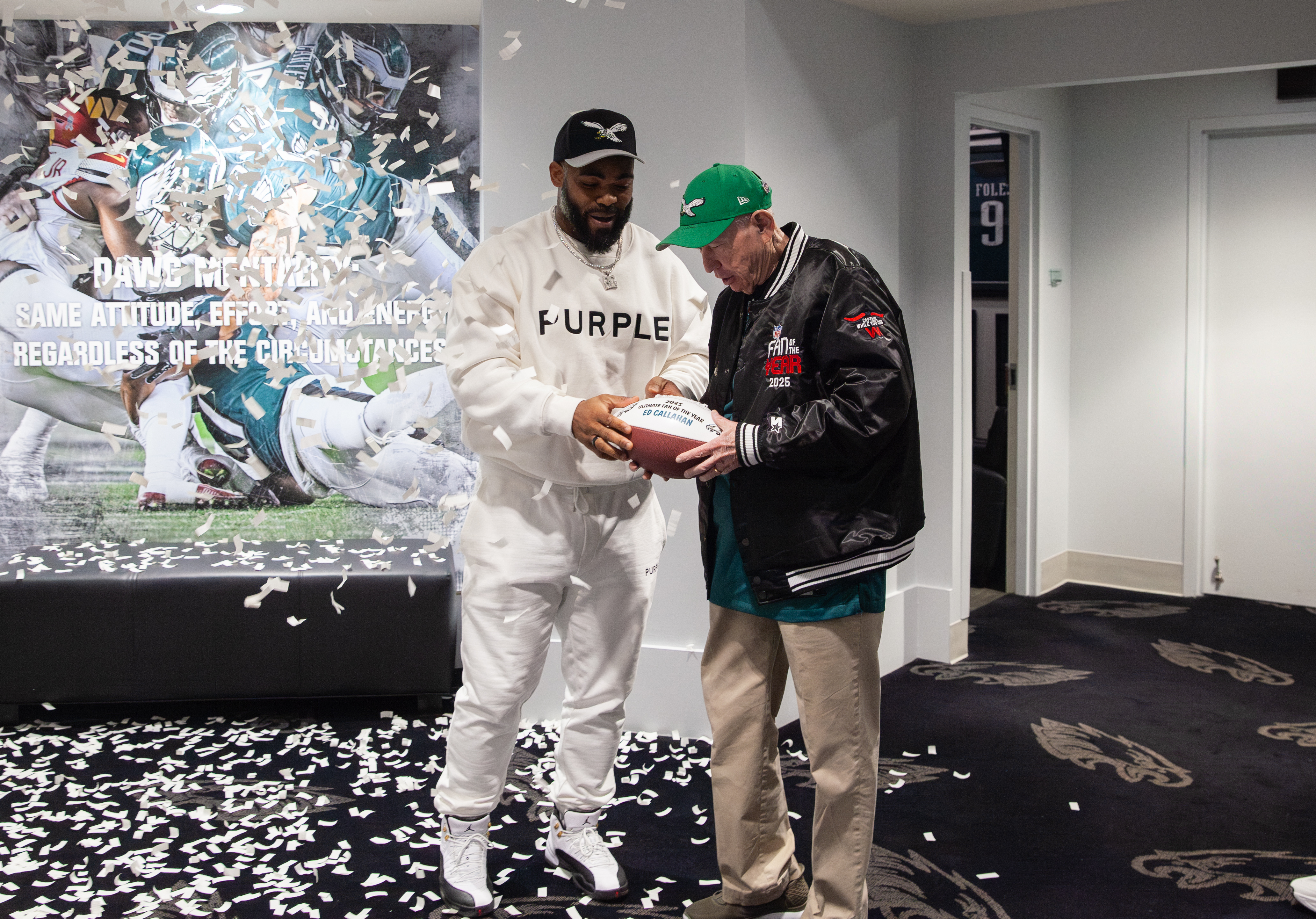 FOTY winner holding oversized ticket, cheering