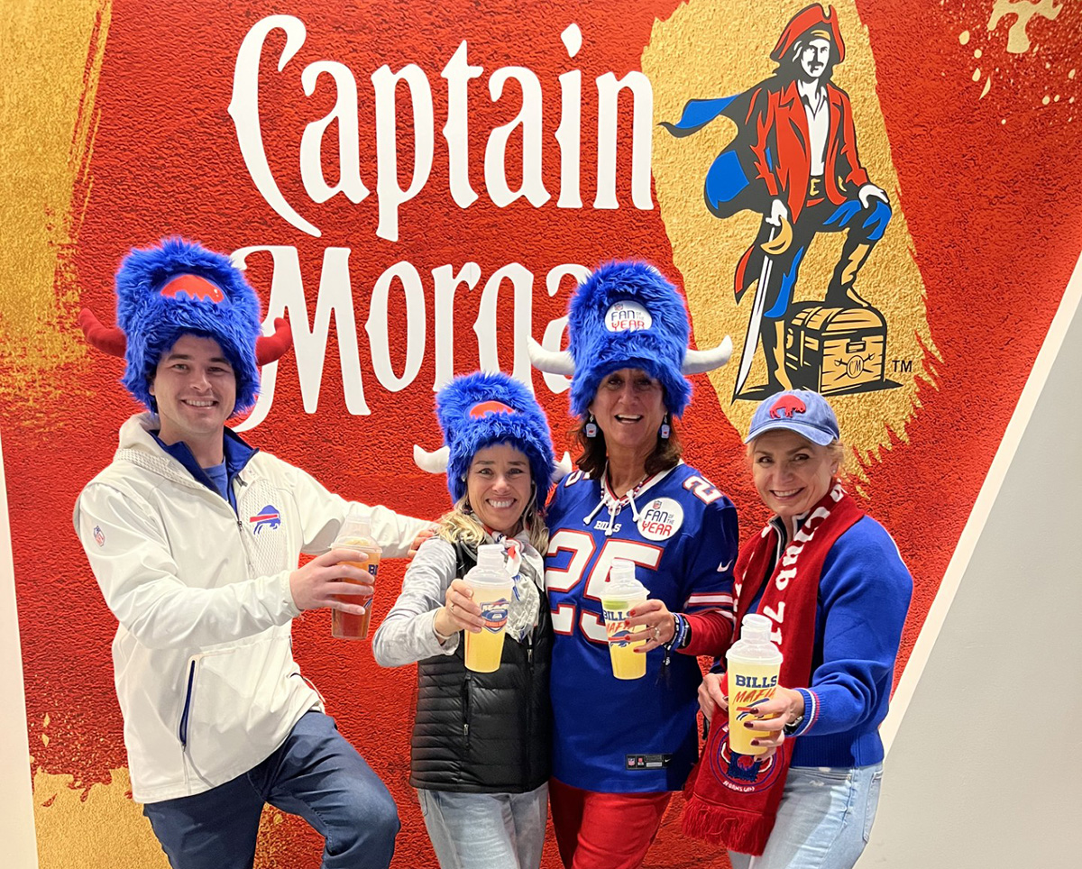 FOTY winners in a group photo holding drinks with a Captain Morgan background