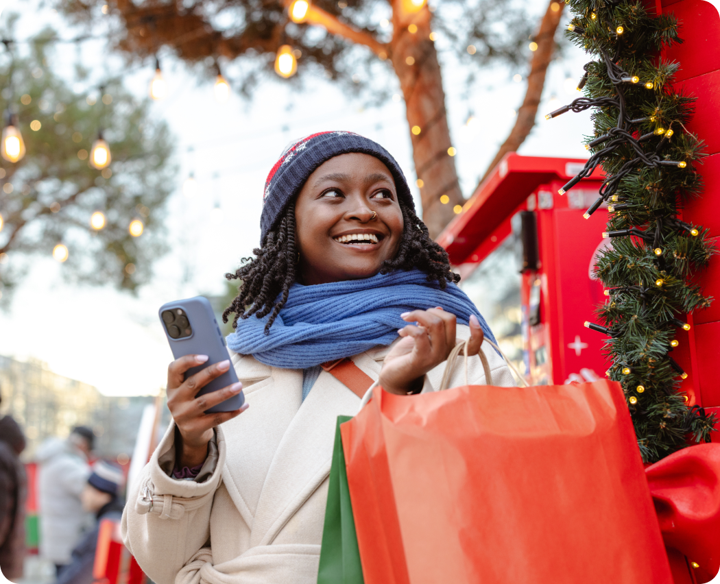 Shopper using a mobile phone to make a contactless payment at a retail checkout