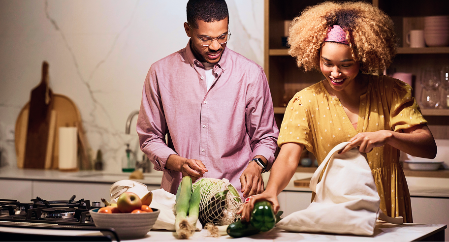 Couple unpacking fresh groceries in their kitchen, illustrating flexible grocery payments with Zip buy now, pay later