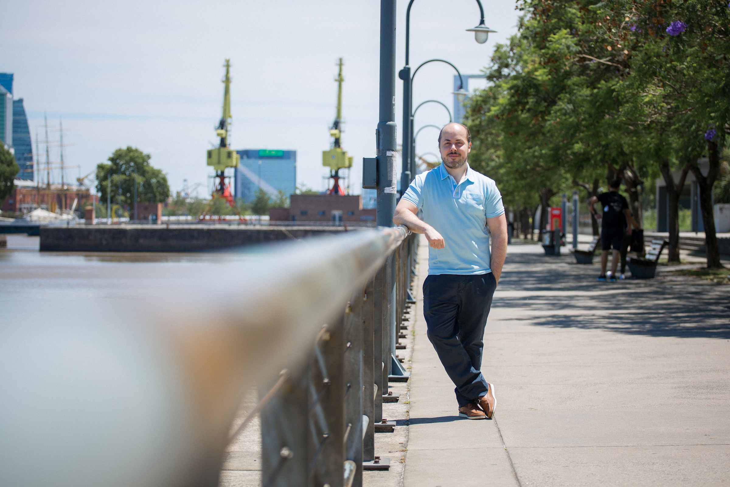 Author Leonardo leaning against a railing on a boardwalk