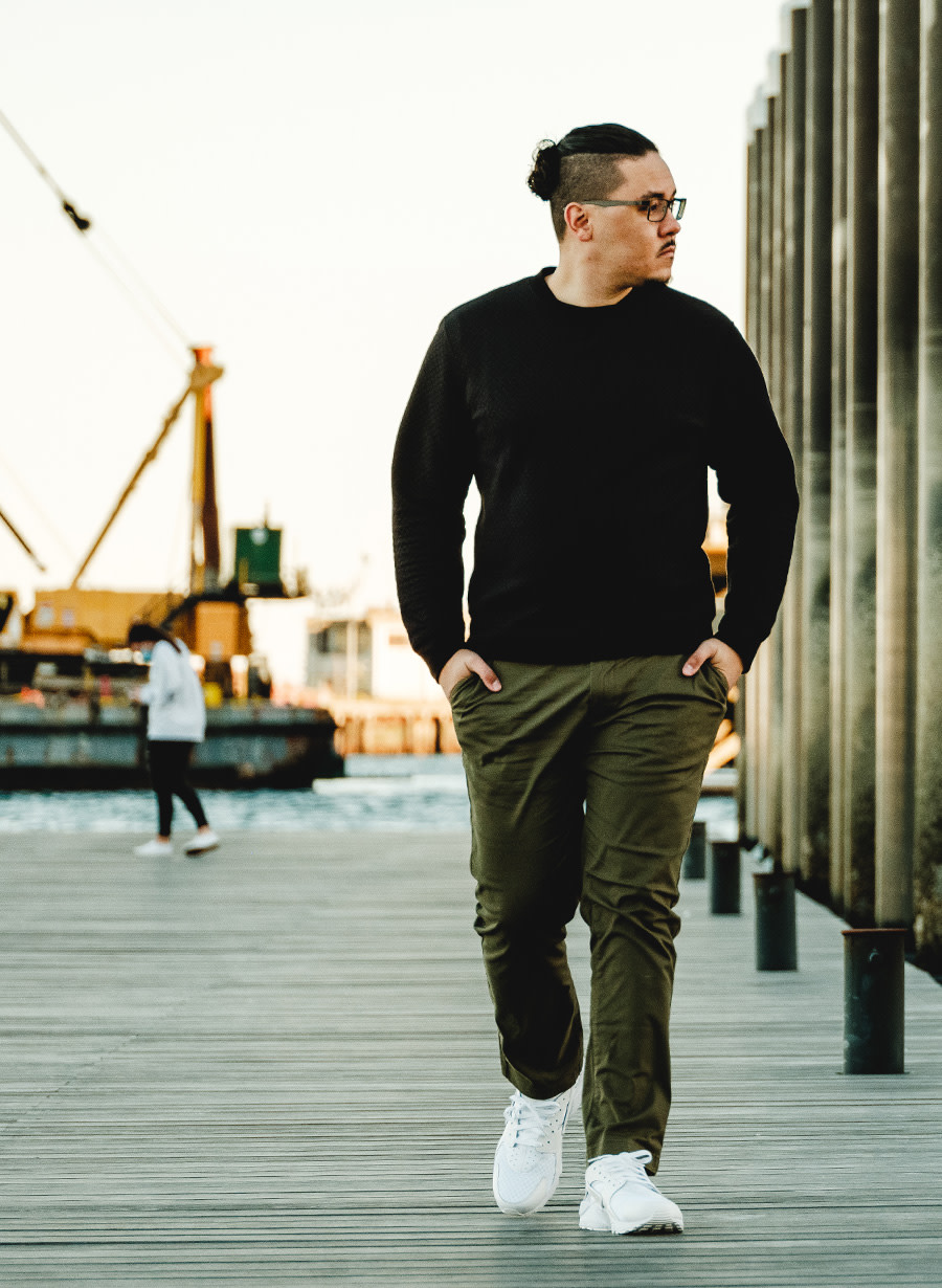 Photo of Nick DeJesus walking along a dock.