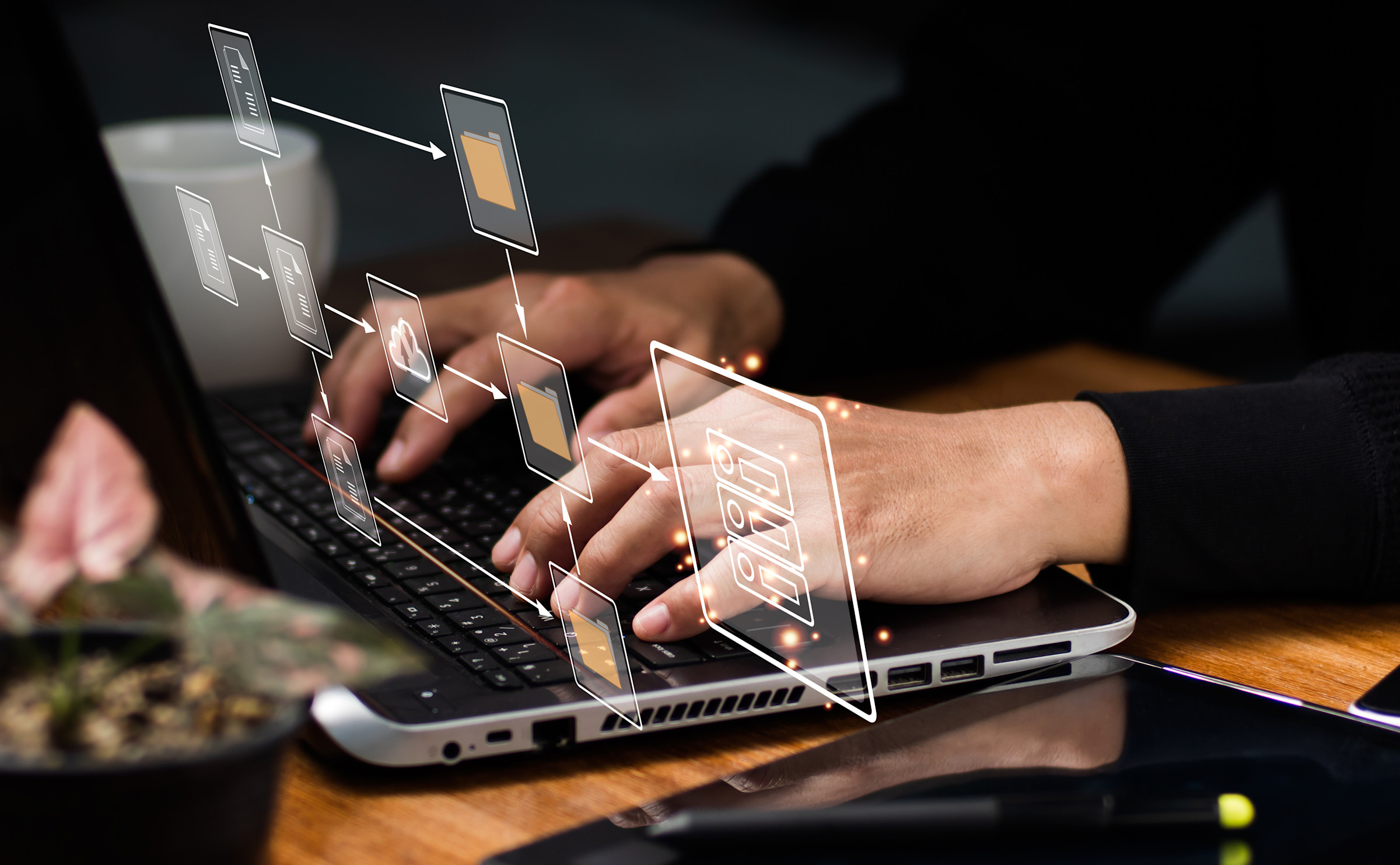 Hands on a keyboard with a floating graphic of all the connections being made