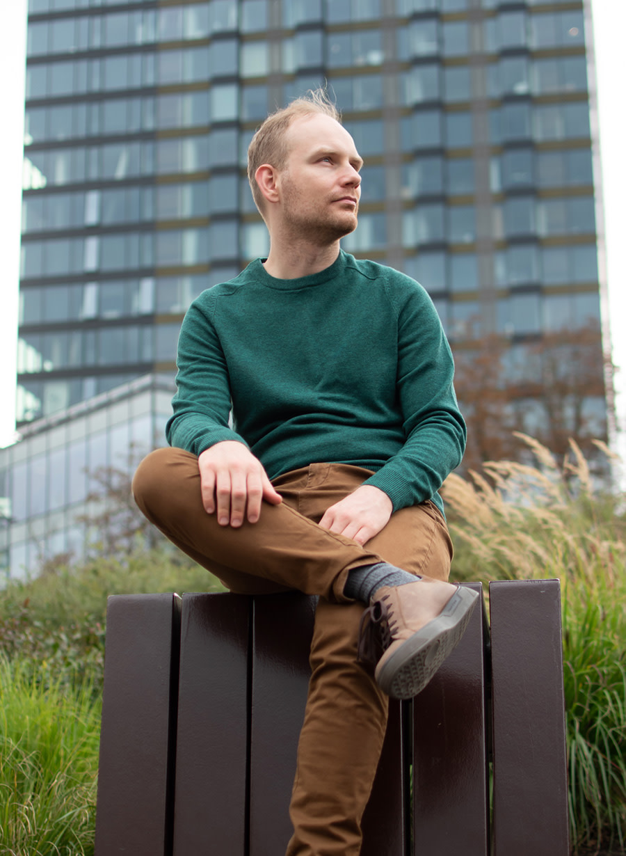 Photo of Michał sitting outdoors.