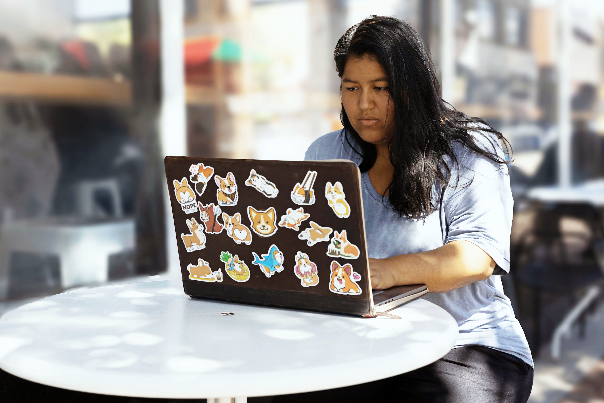 Author Frances working on her computer at an outdoor cafe