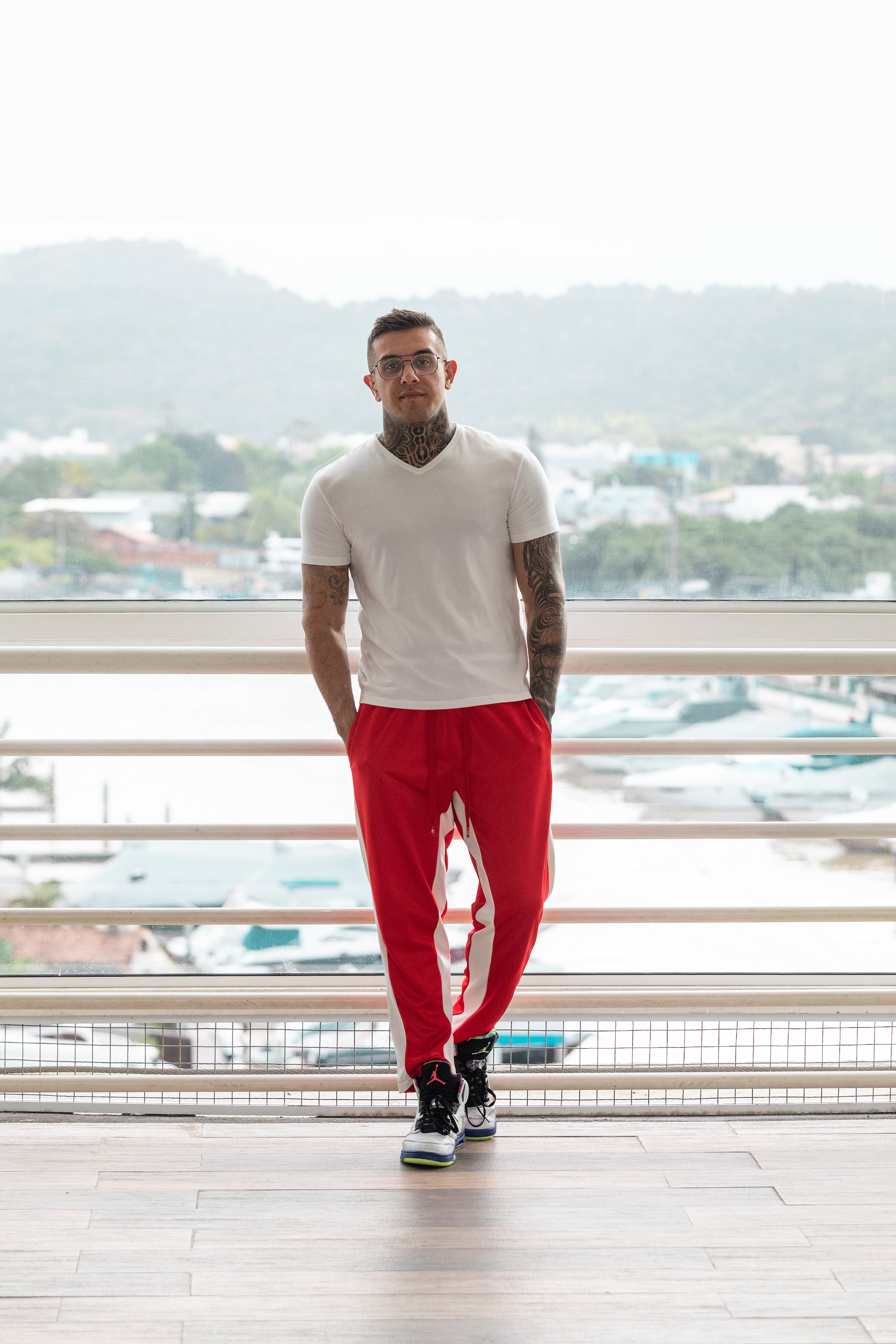 Author Pedro standing on a balcony with a marina behind him