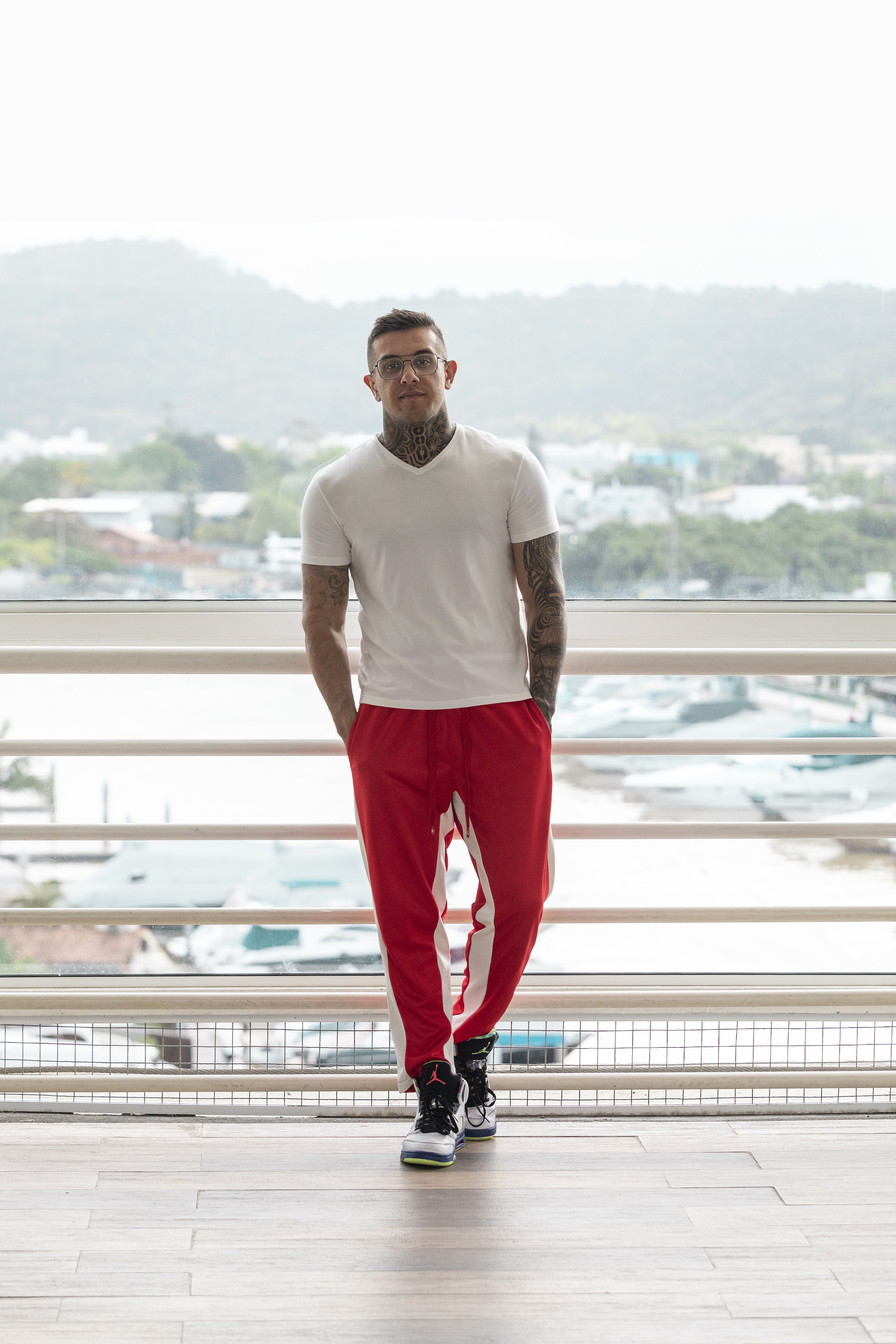 Author Pedro standing on a balcony with a marina behind him