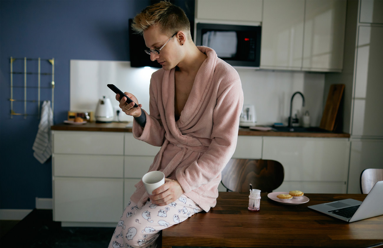 Man sitting on table with phone in hand.