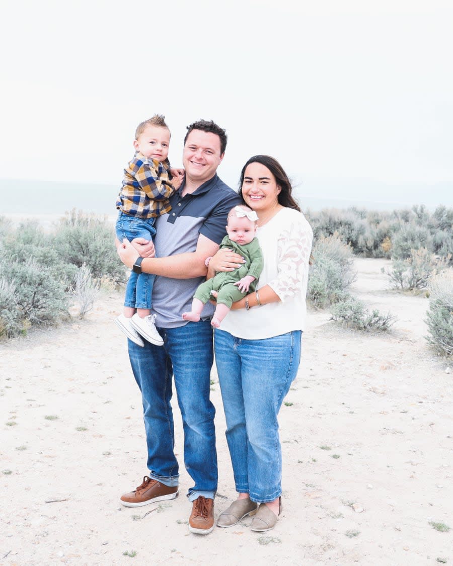 Photo of Tanner Linsley on the beach with his wife and children.