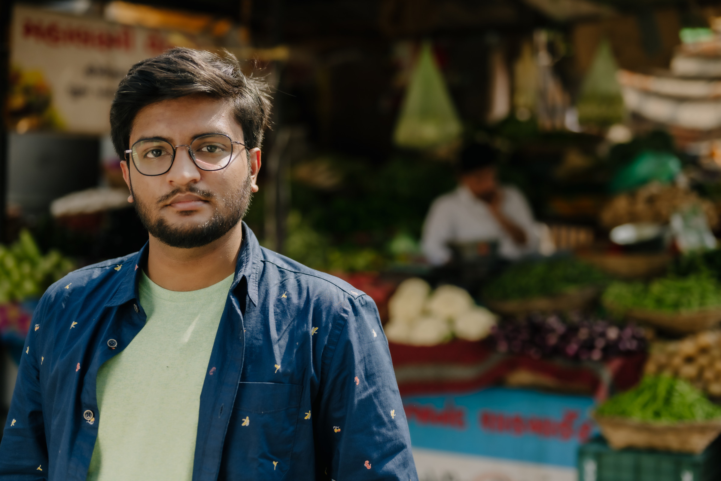 Author Karthik standing in front of an outdoor food market