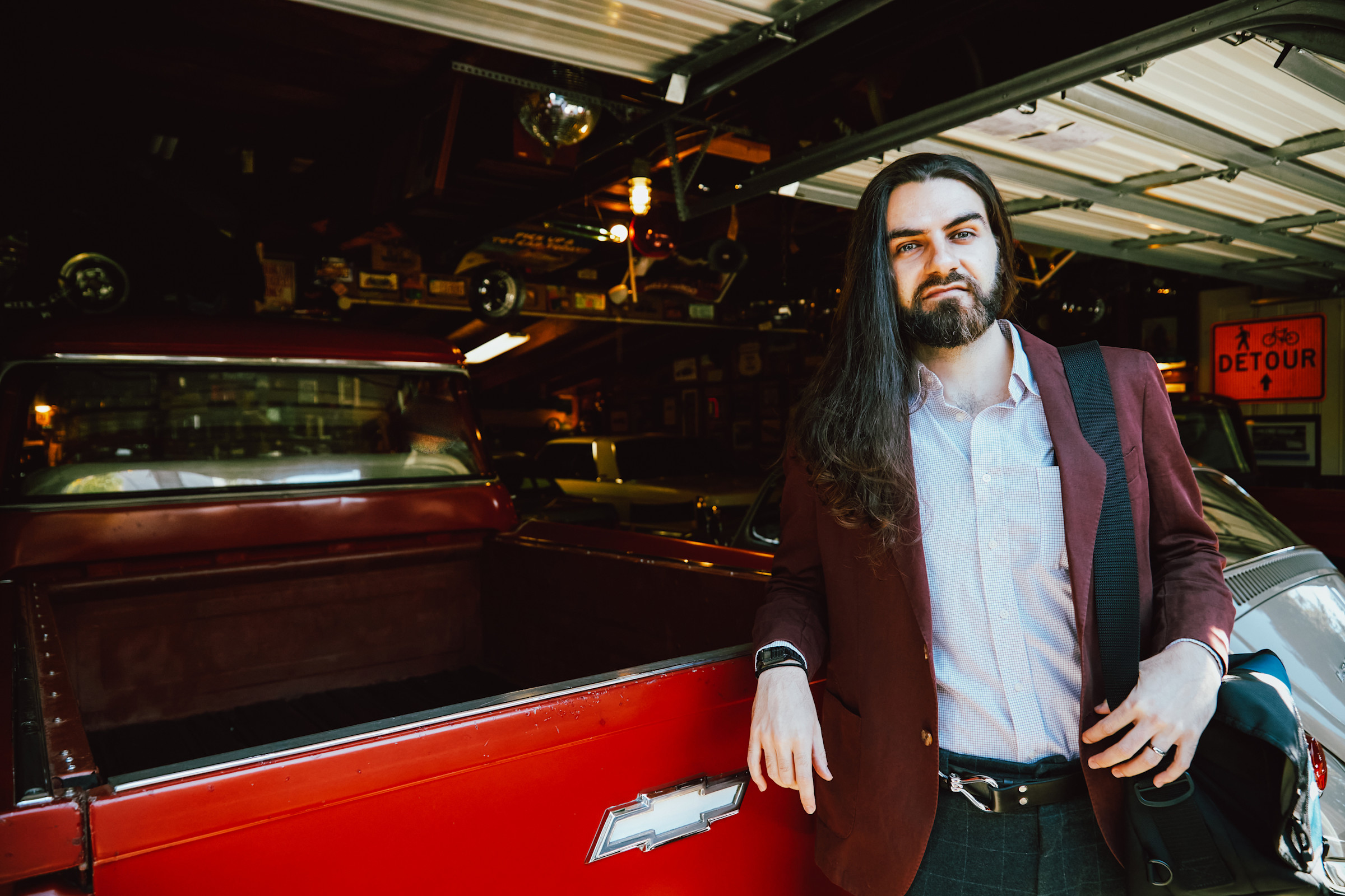 Author Mahmoud leaning against a red Chevy truck