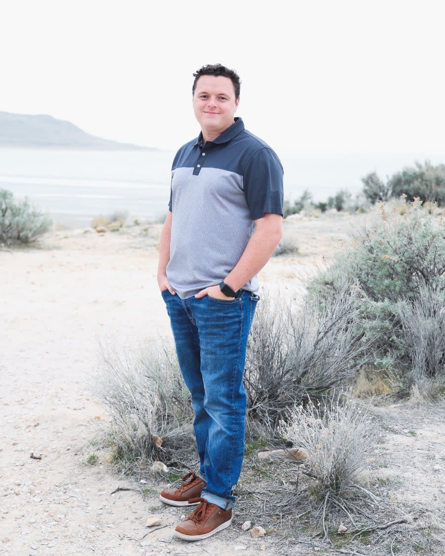 Photo of Tanner Linsley on the beach standing.