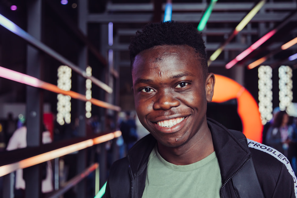 Samson Goddy smiling brightly at GitHub Universe.