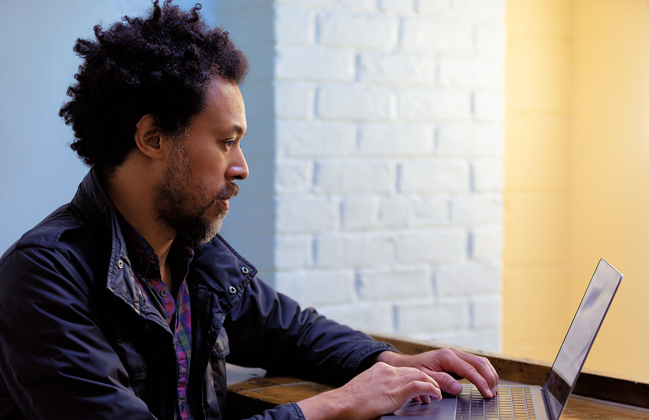 Photo of David working intently on his laptop.