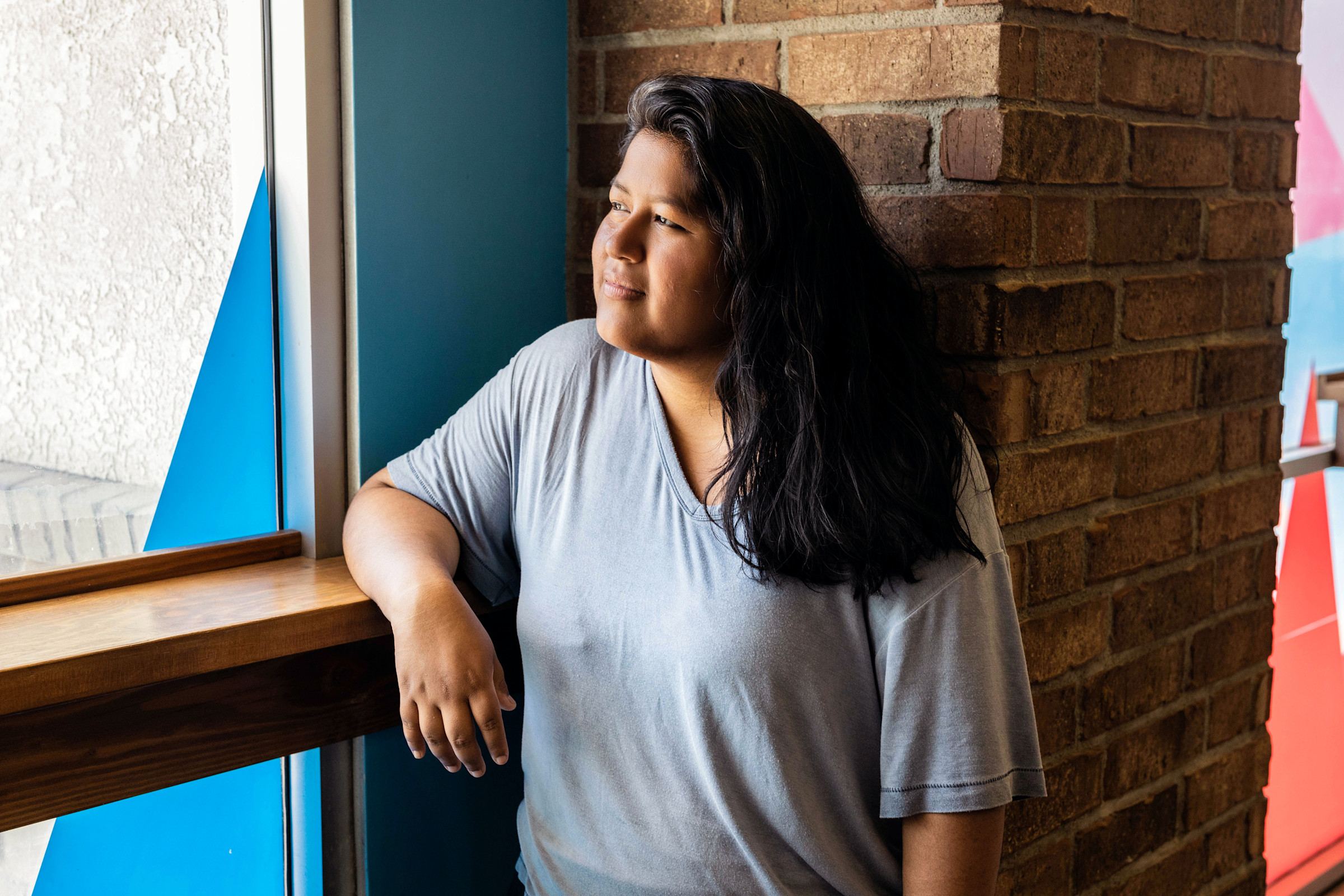 Author Frances gazing out a sunny window