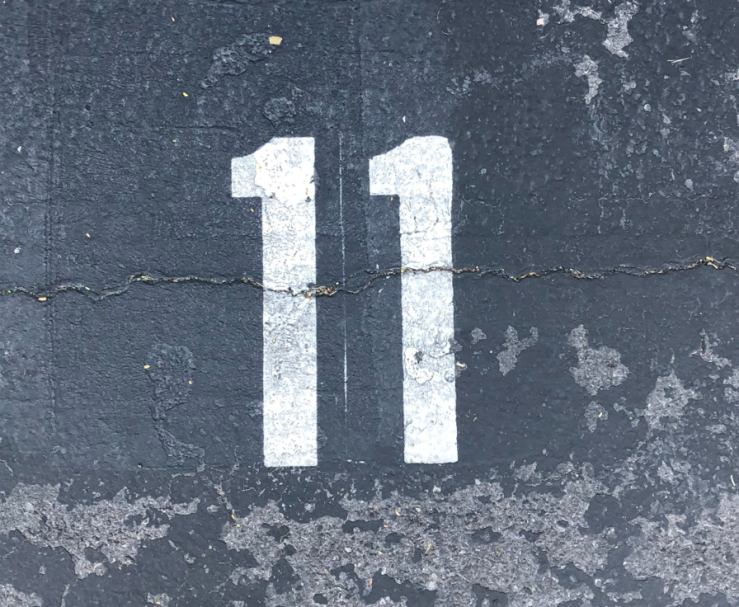 Image showing number eleven painted on the road. 
