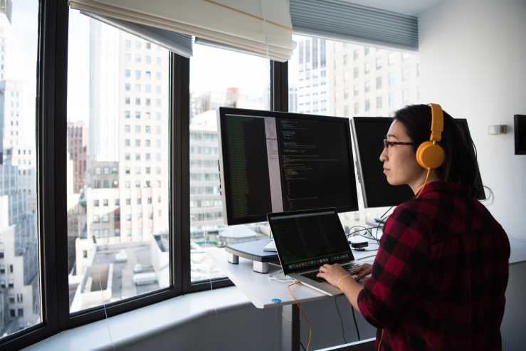 Woman coding in her city apartment