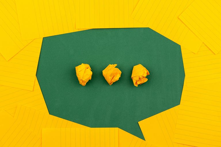 Typing text bubble made from green and yellow paper