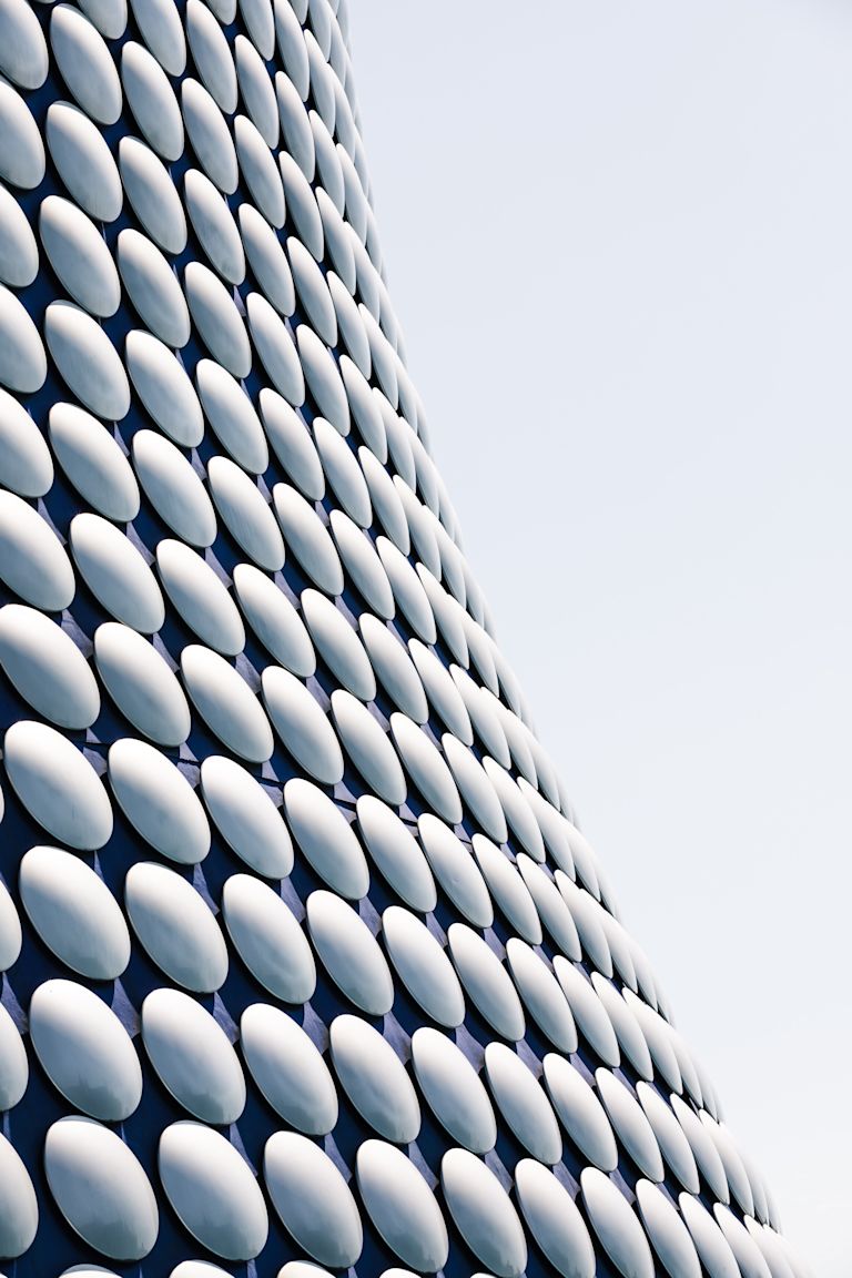 Modern architecture with a grid of mirrors on a building 