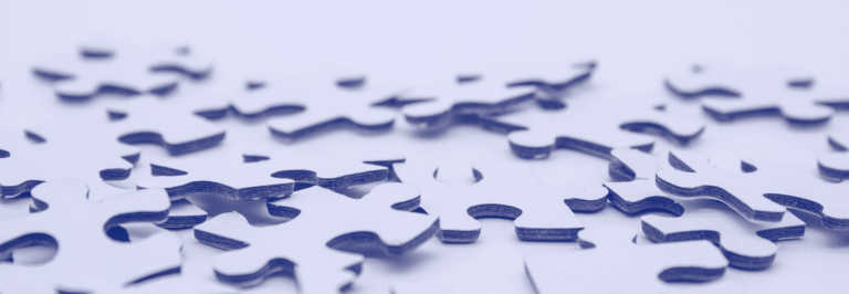 Puzzle pieces sit on a table representing copy and paste - elements being taken apart and put back together. by Mel Poole