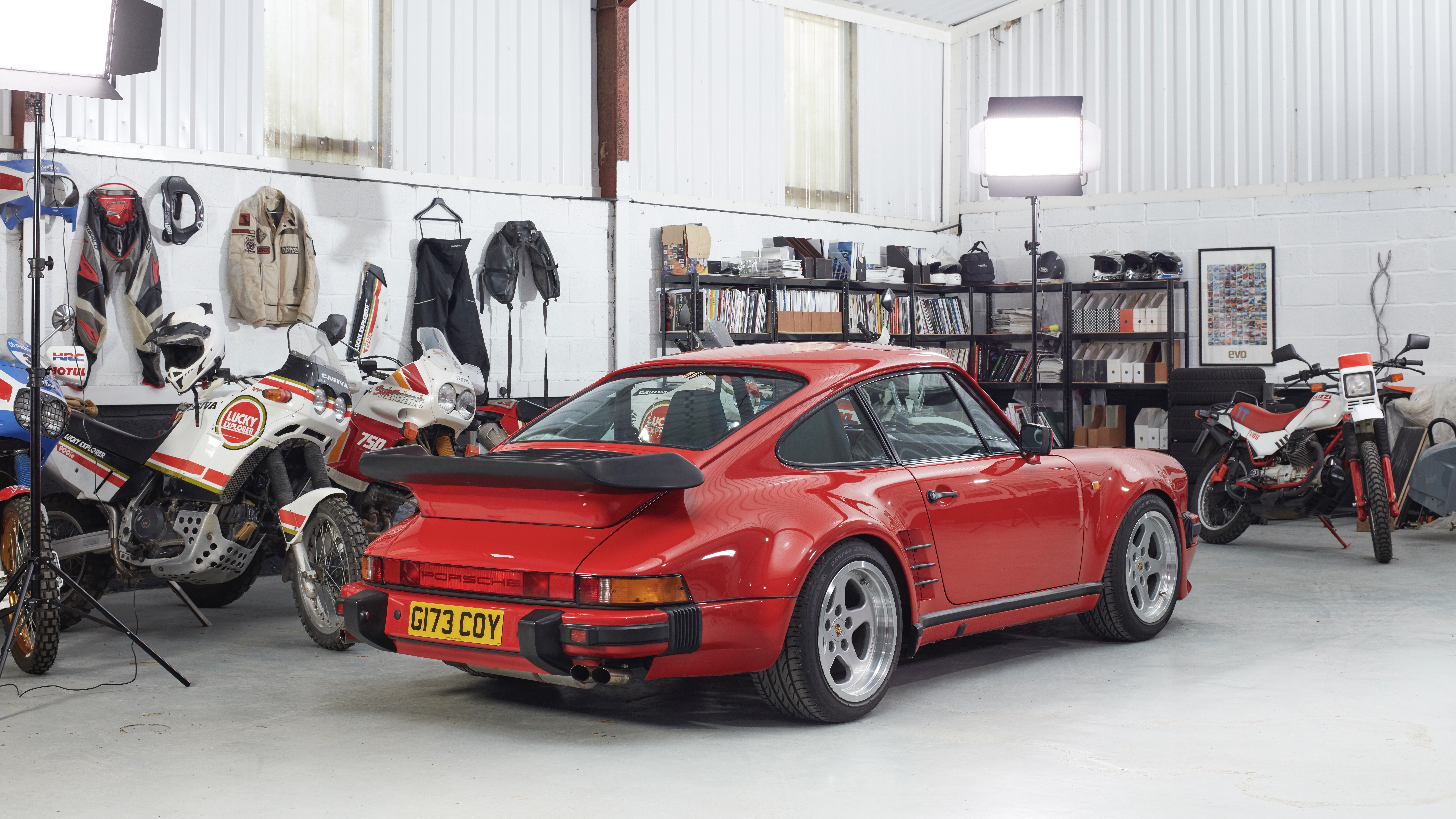 Porsche 930 Turbo S in Guards Red, surrounded by motorbikes